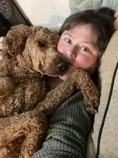 Customer hugging their dog